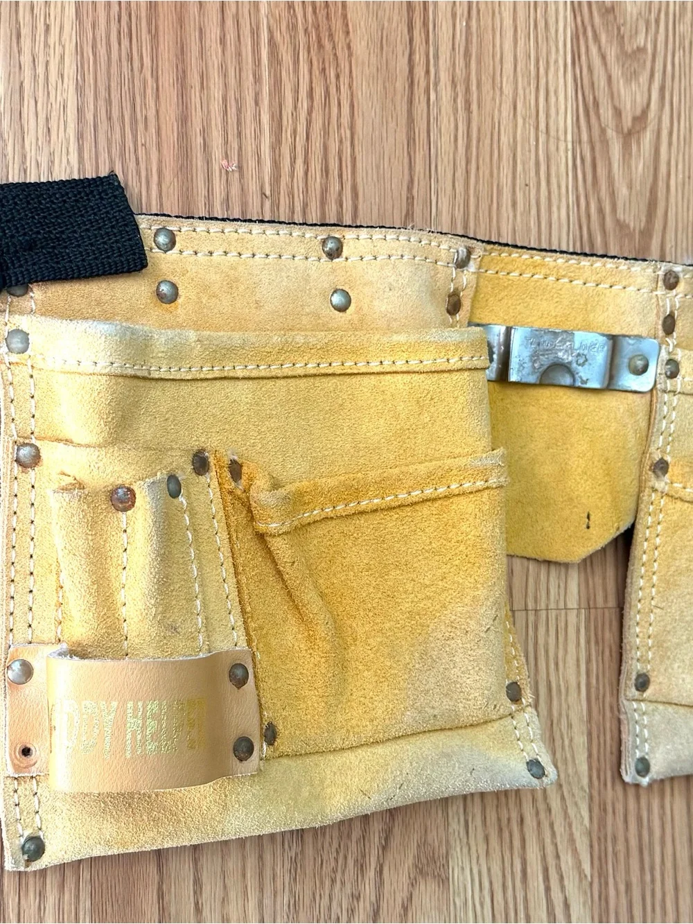 Suede leather Tool-belt that says ”Daddy Helper”n large gold letters in front.